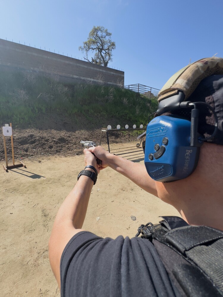 Shooter testing the Charter Arms Coyote .380 ACP revolver on a controlled outdoor range