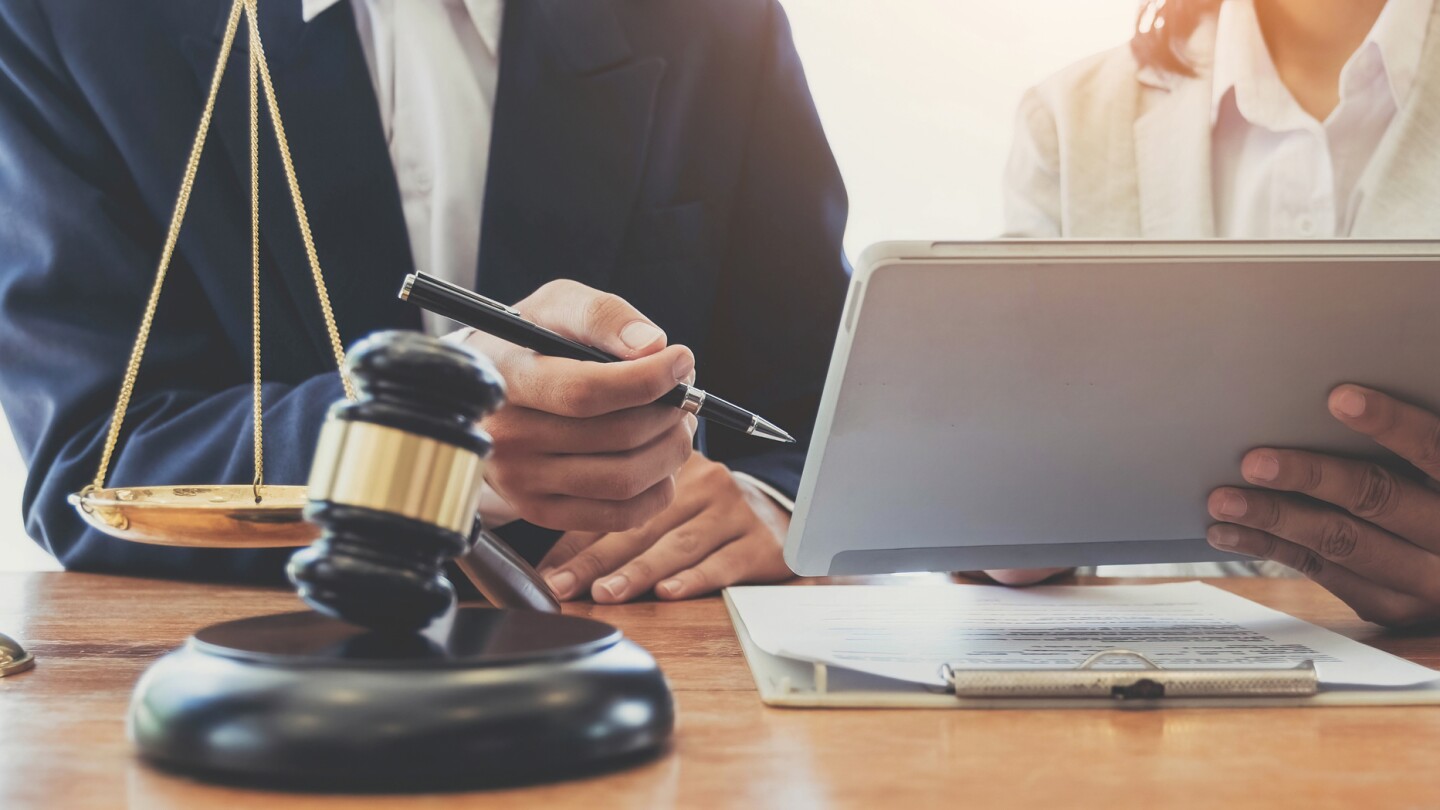 Consultation of Businessman or lawyer team meeting with client, Law and Legal services concept, Good service cooperation, Hands using tablet and laptop.