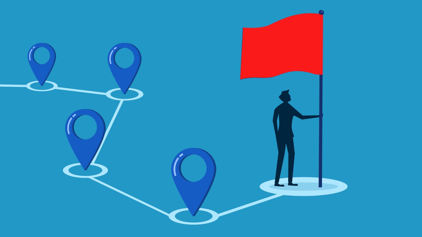 Take over the place. Businessman putting red flag on location