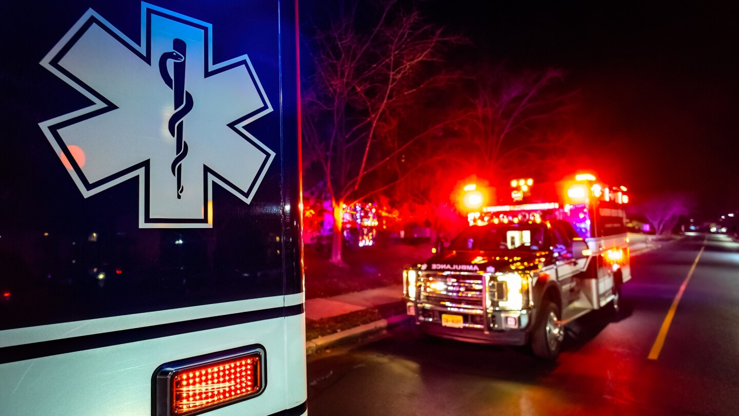 Close up emergency ambulance truck illuminated at night