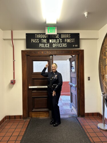 Captain Julie Rodriguez pictured under the LAPD Police Academy sign.jpg