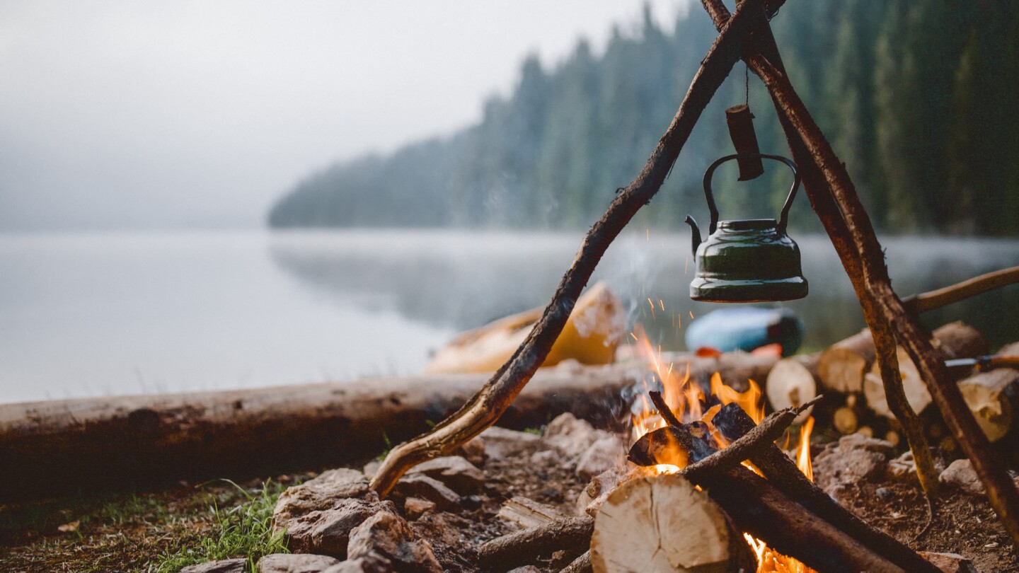 Shot of a cute vintage teapot in a campsite near to lake.