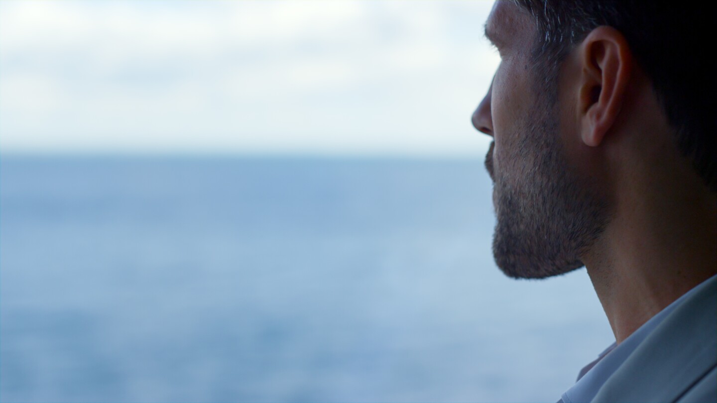 Sad man watching sea view closeup