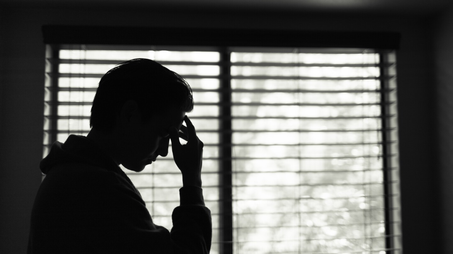 Man at home feeling tired and stressed.