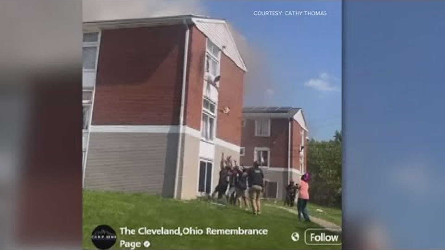 Watch as a baby is dropped from a window after an explosion and fire at ...