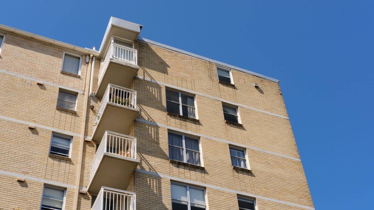 Old brick apartment building with a column of balconies