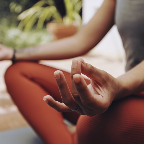 Woman, mudra hands and meditation for wellness, freedom and calm chakra energy in garden, park and zen. Closeup girl, yoga exercise and meditate in lotus outdoors for mental health, hope and mindset