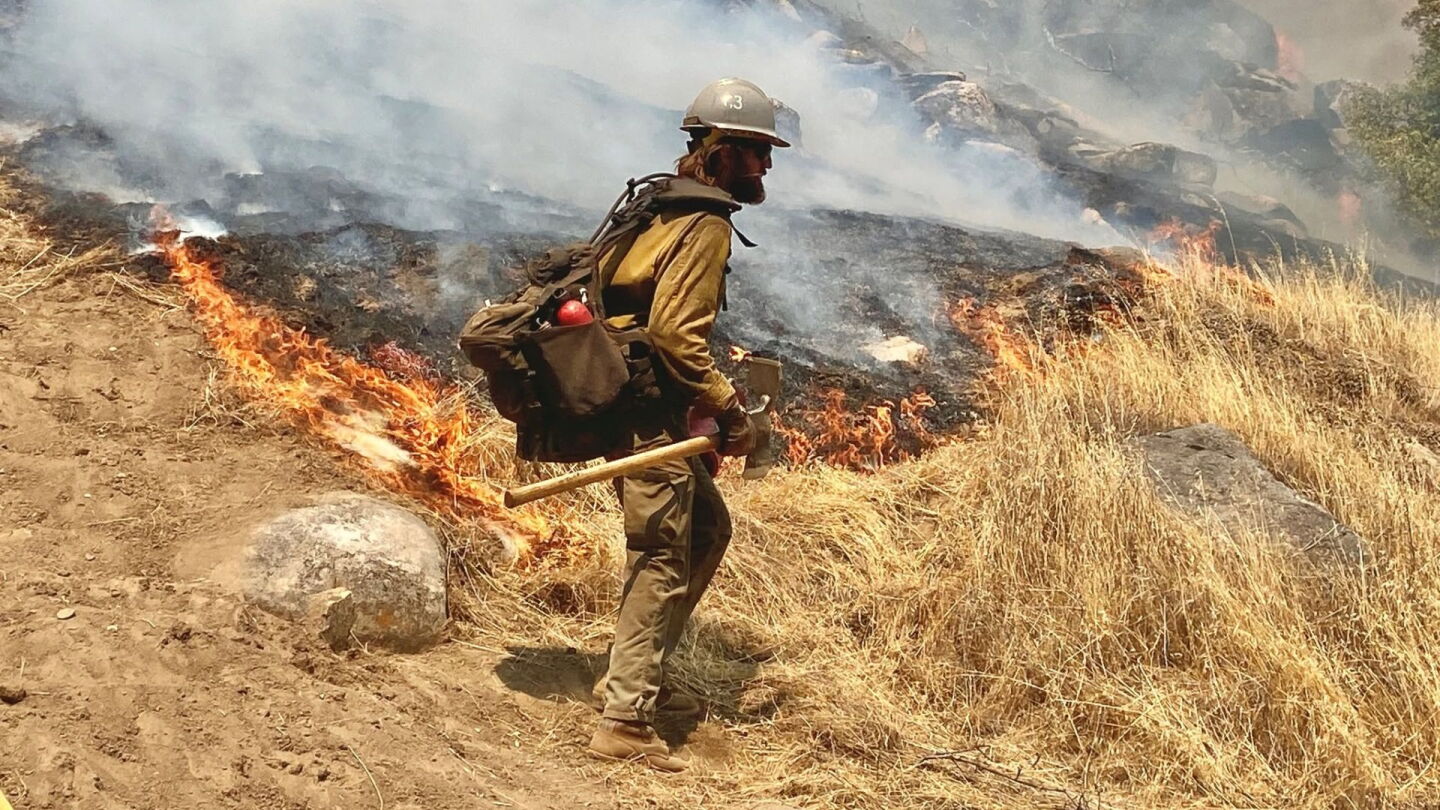 Wildland firefighters on the fireline in wildfire smoke