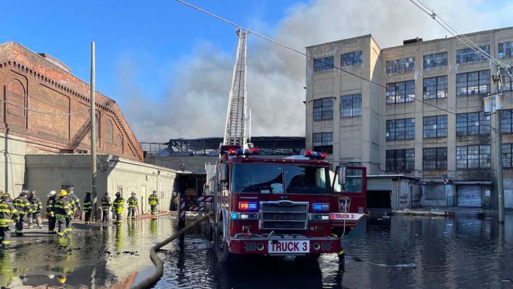 N.J. 4-alarm factory fire continues to smolder