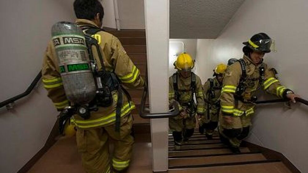 Firefighters_with_Commander__Navy_Region_Japan_climb_the_stairs_of_a_housing_tower_at_Naval_Air_Facility_Atsugi__Japan__Sept_140911-N-OX321-348.jpg