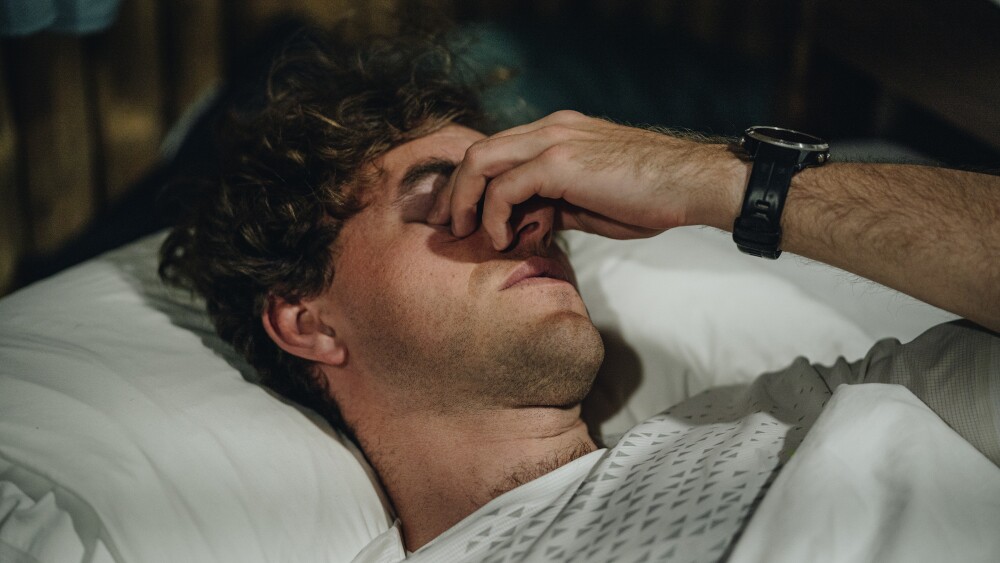 Portrait of young man waking up in the morning