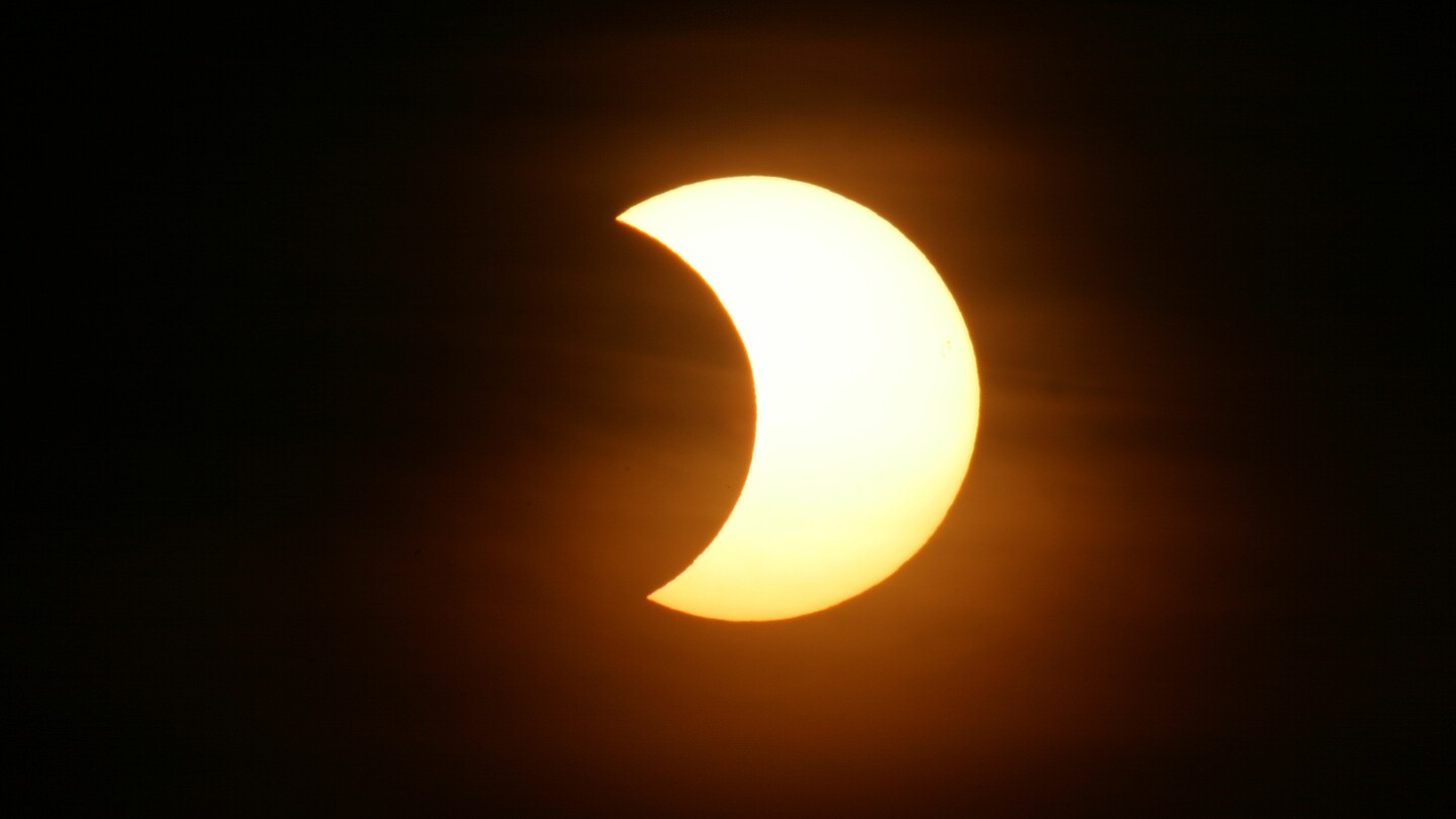 The nights sky with a partial solar eclipse