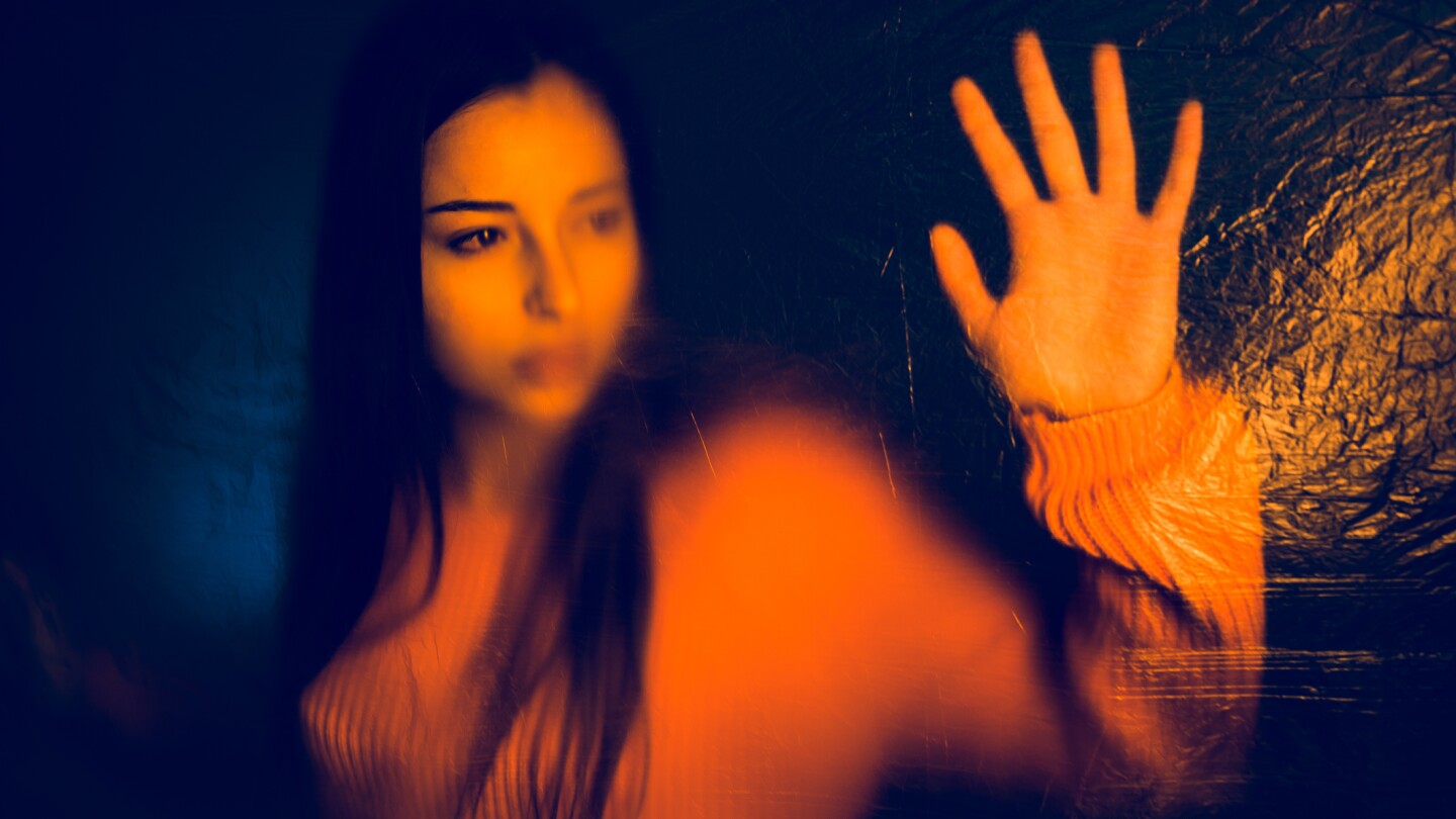 Portrait of teenage girl trapped behind the plastic nylon foil, human rights antipollution trafficking concept