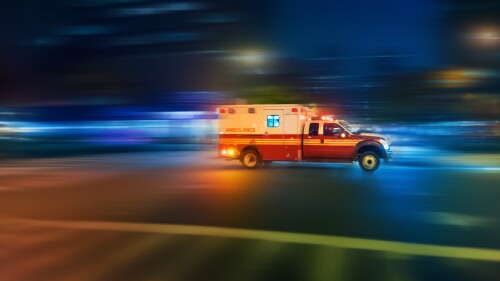 Ambulance speeding at night on an urgent call in Manhattan New York - motion blur panning action