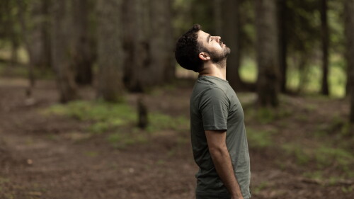 Young man relaxing in forest