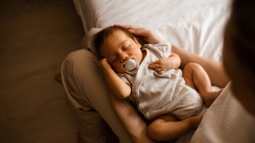Baby lying on mother hands